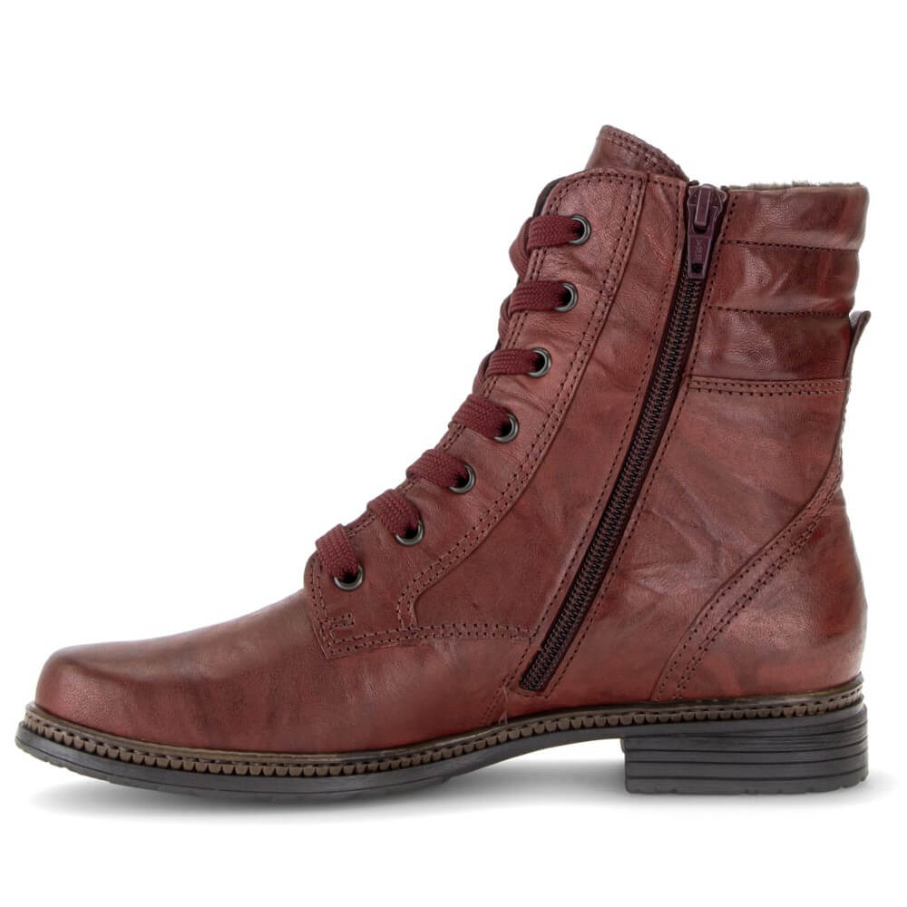 A Gabor mid-calf lace-up ankle boot in distressed reddish-brown leather, featuring a side zipper, dark metal eyelets, and a low stacked heel, shown against a plain white background.