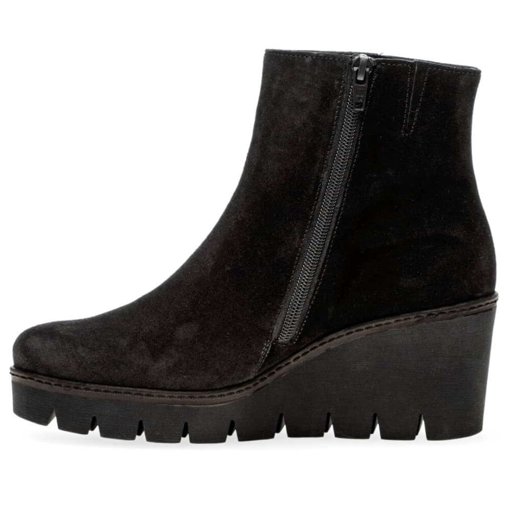 A black suede ankle boot with a chunky black platform wedge sole and a side zipper, shown from a side profile view on a white background.