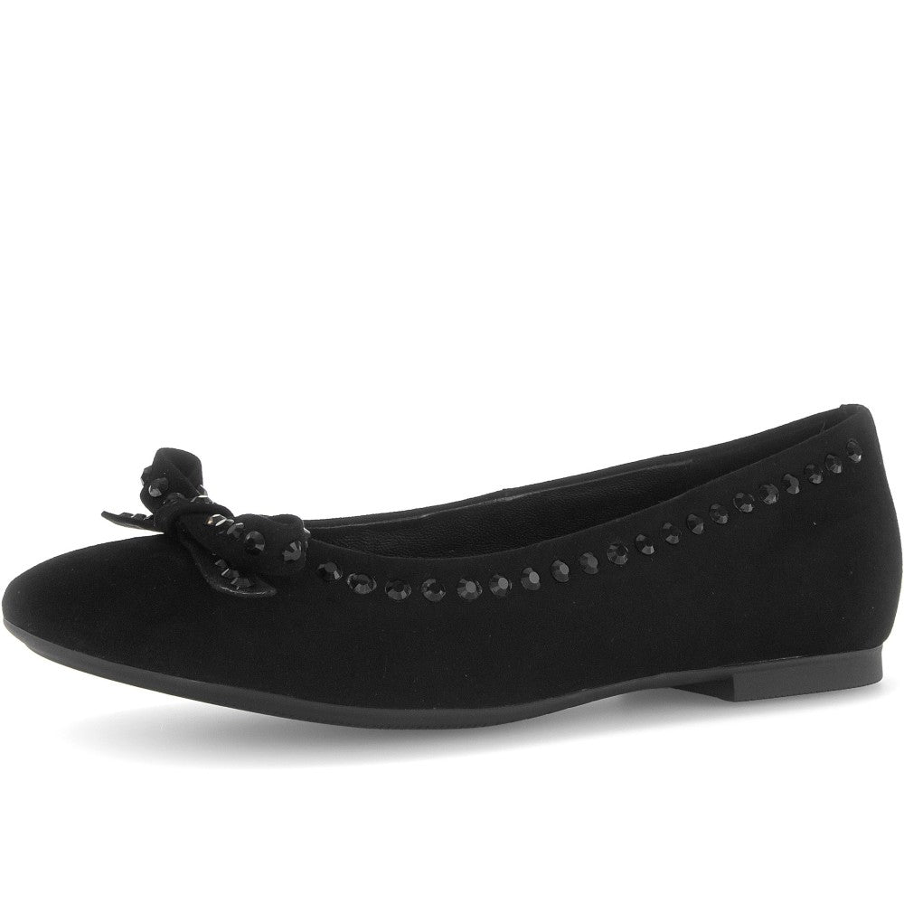 Black flat shoe with decorative elements on a white background