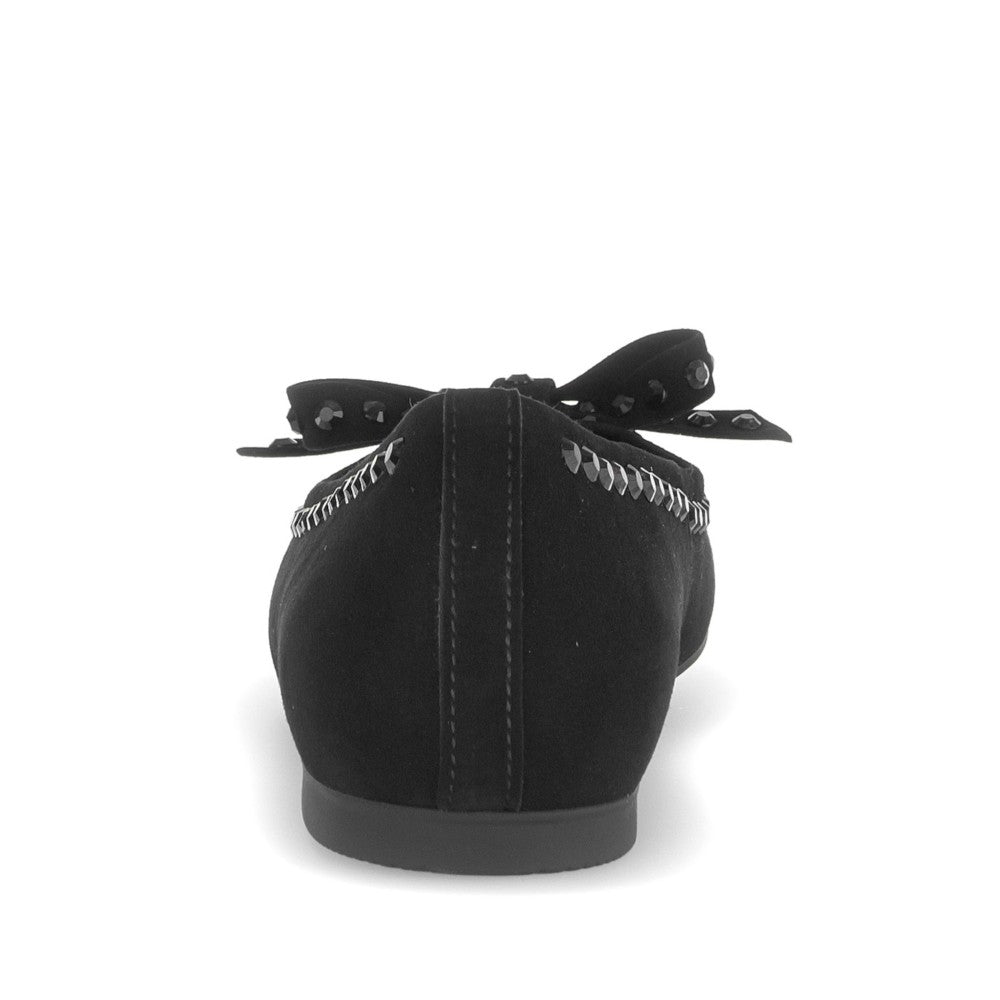 Black flat shoe with decorative elements on a white background