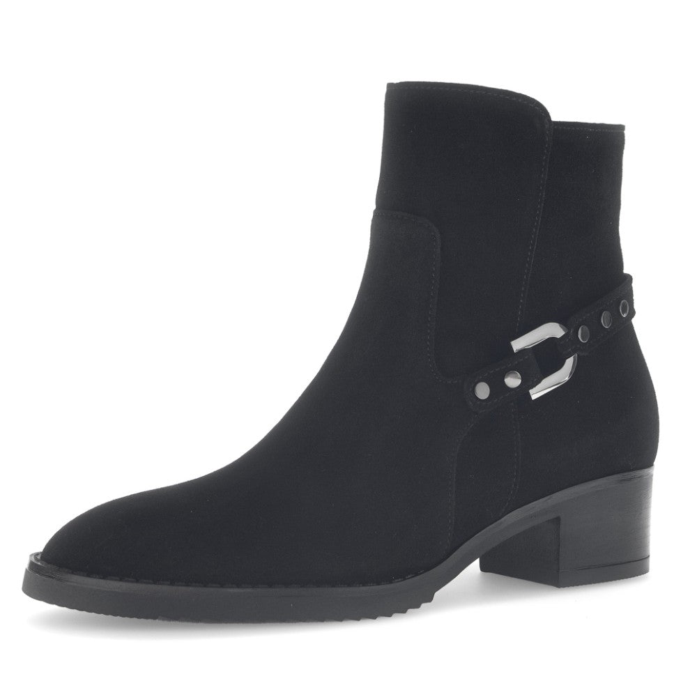 Black ankle boot with a buckle on a white background
