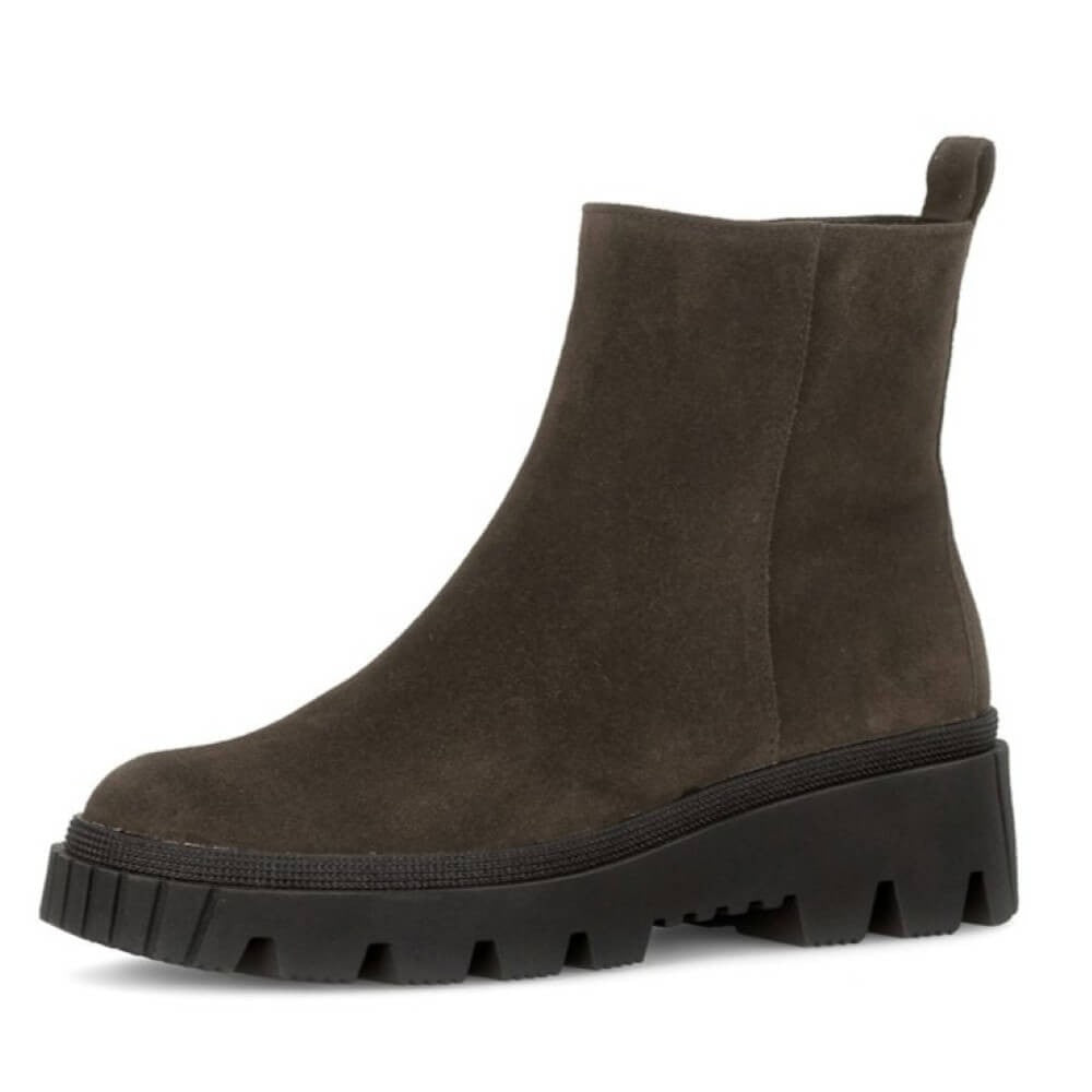 Brown suede ankle boot with a thick sole on a white background
