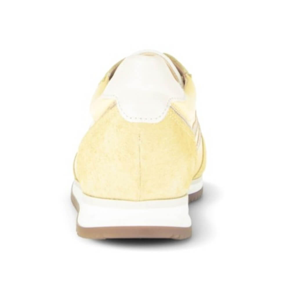 Yellow sneaker with white sole on a white background