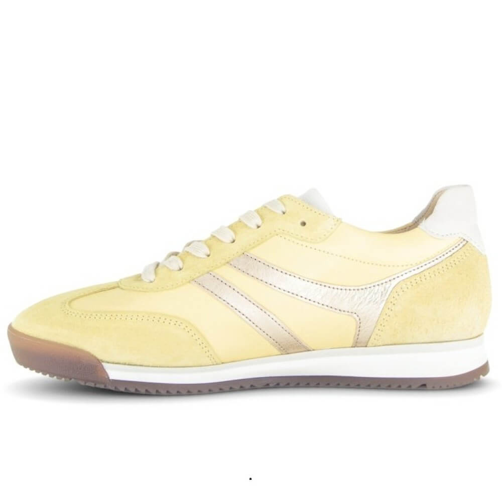 Yellow sneaker with white sole on a white background