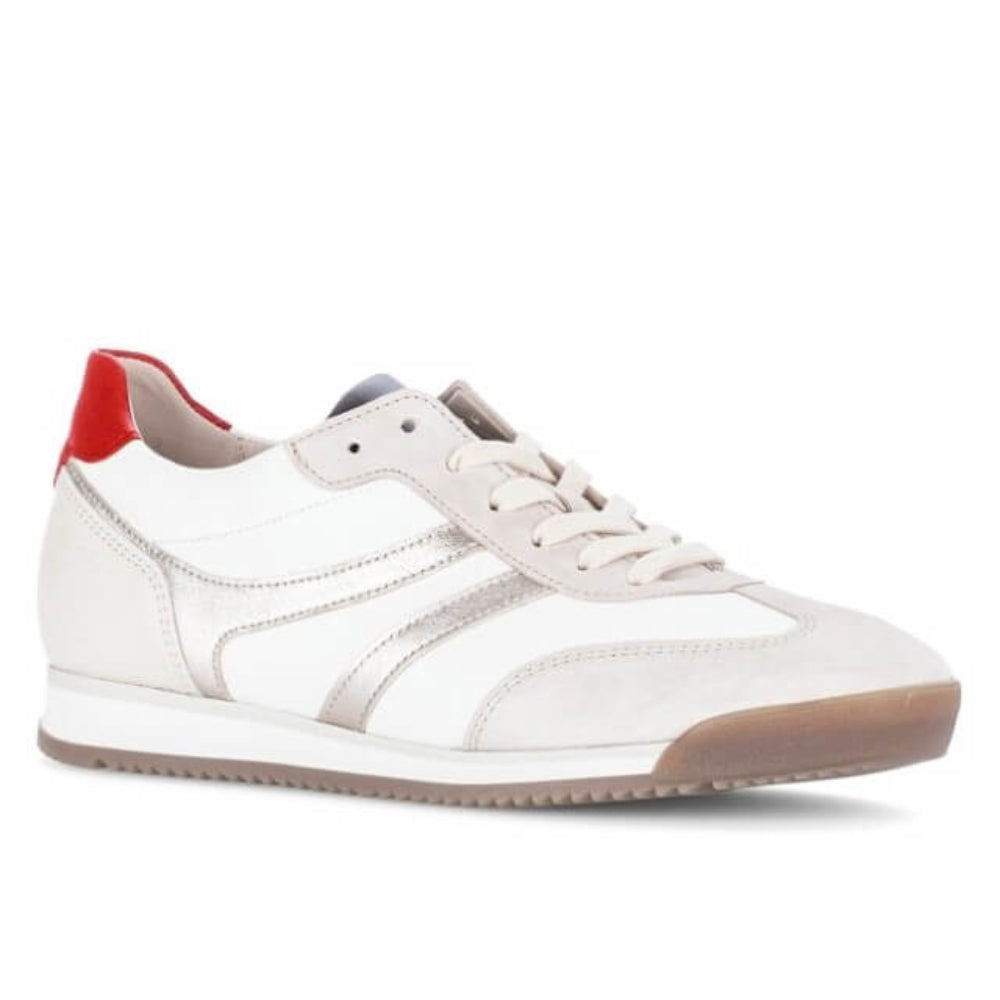 White sneaker with red heel tab on a white background