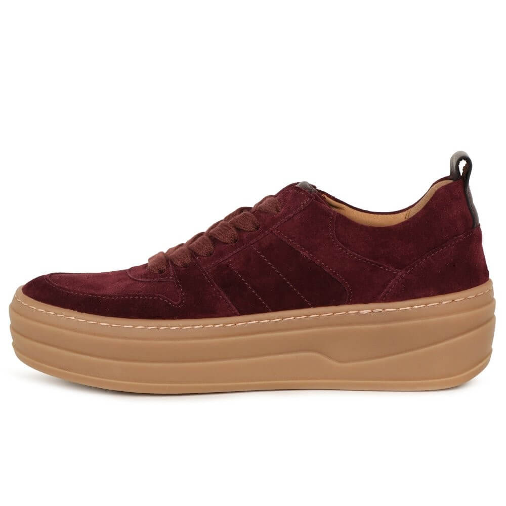 Maroon sneaker with a tan sole on a white background