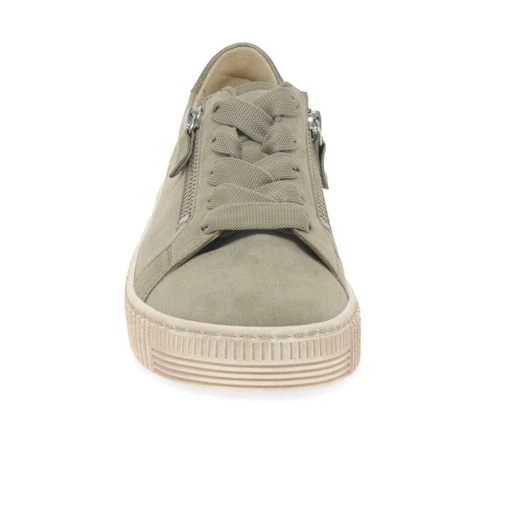 Green sneaker with a white sole on a white background