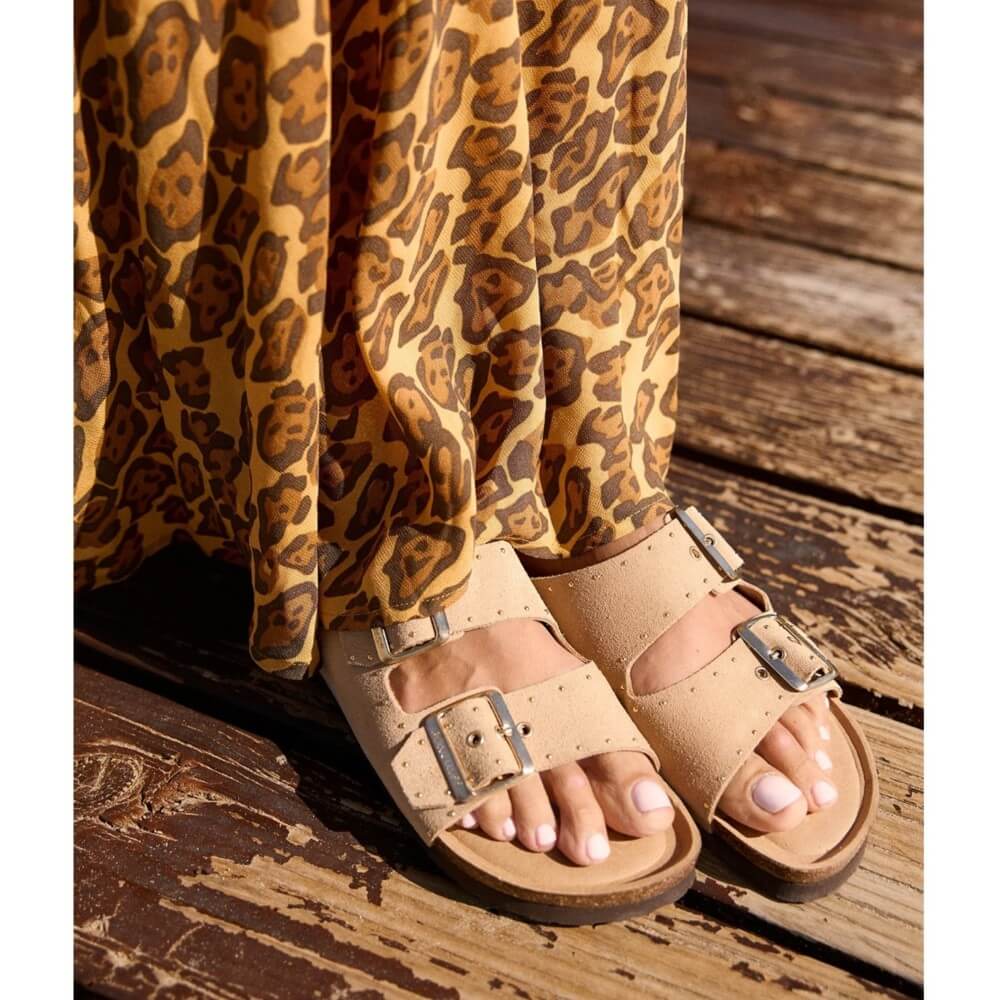 Genuins Beige sandals worn with leopard print pants on a wooden floor
