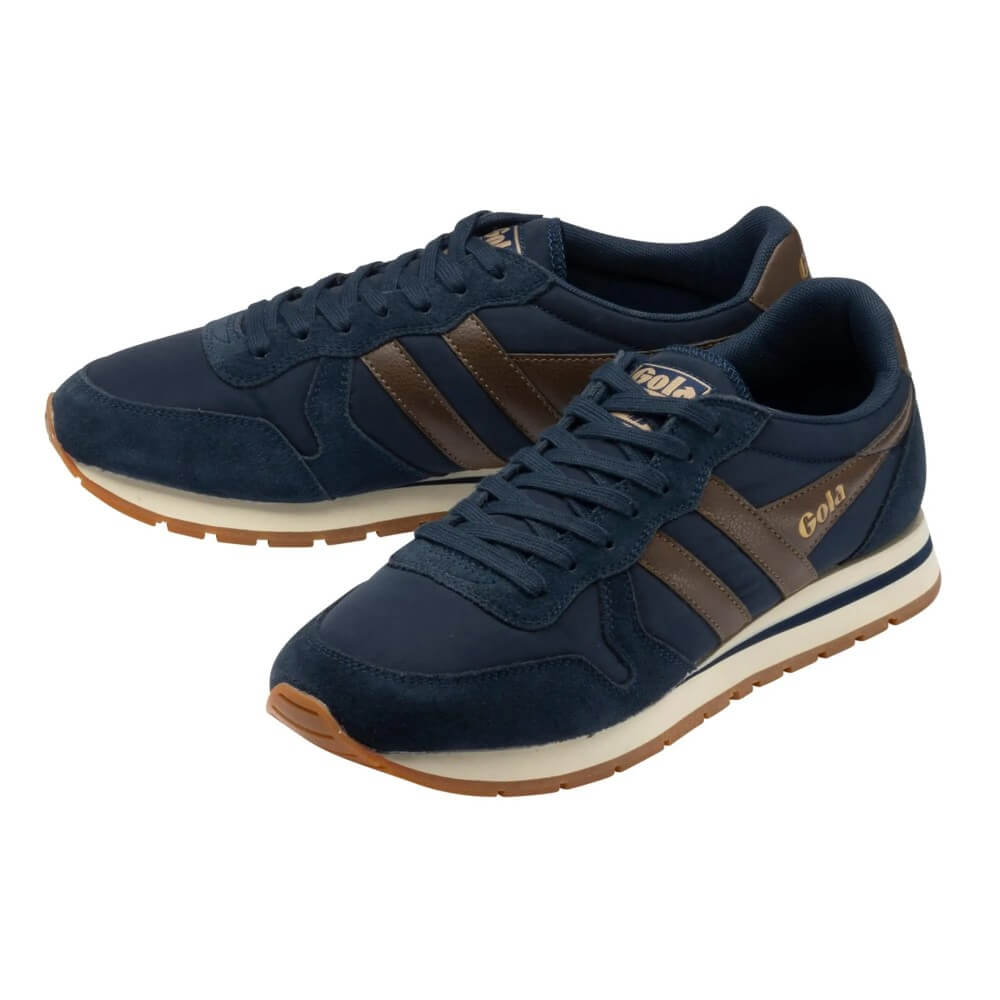 A pair of navy blue suede and leather sneakers with brown side stripes, a cream midsole, and a gum outsole. The brand name 'Gola' is printed in gold on the side and tongue.
