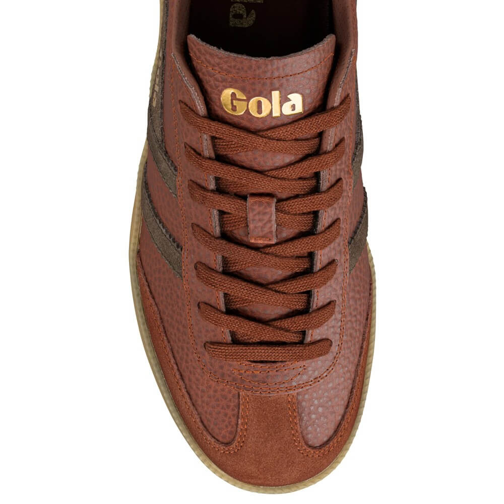 A top-down view of a brown leather sneaker with matching brown laces, featuring a gold 'Gola' logo on the tongue and a light tan sole, set against a plain white background.