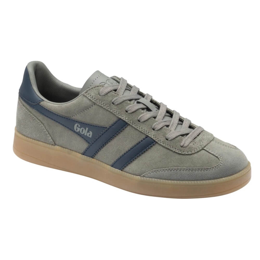 A light gray suede sneaker with navy blue side stripes and the brand name 'Gola' printed on the side, featuring a gum sole.