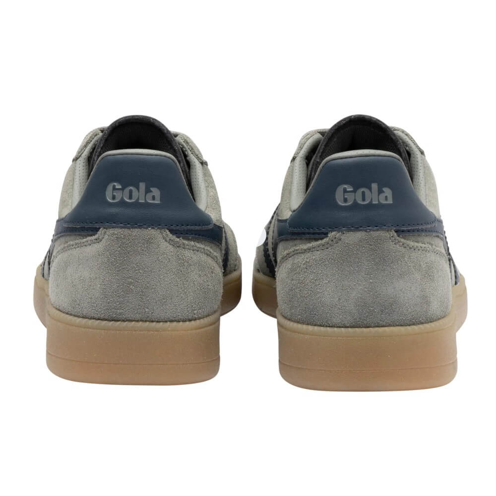 A pair of Gola sneakers shown from the back, featuring light gray suede uppers, navy blue heel tabs with the 'Gola' logo, and tan rubber soles, set against a plain white background.