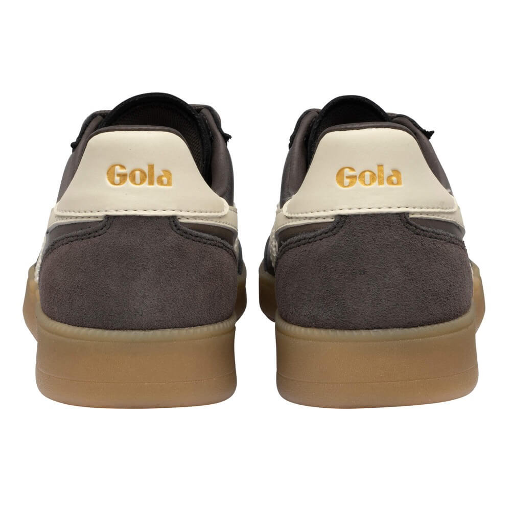 A pair of Gola sneakers shown from the back, featuring dark gray suede and leather panels, a cream-colored heel counter with gold 'Gola' branding, and a gum rubber sole.