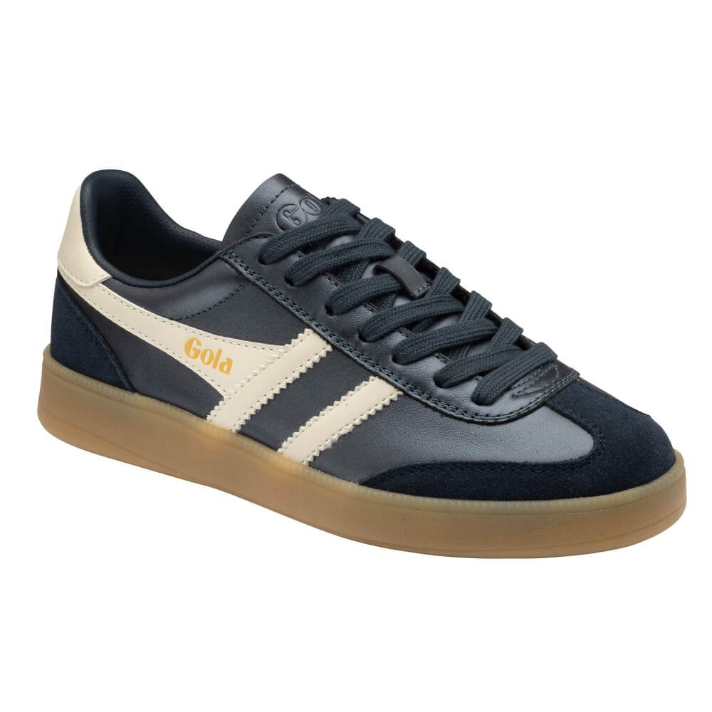 A Gola brand low-top sneaker in navy blue suede and leather, featuring cream-colored side stripes, a cream heel tab, and a gum brown sole, shown against a plain white background.
