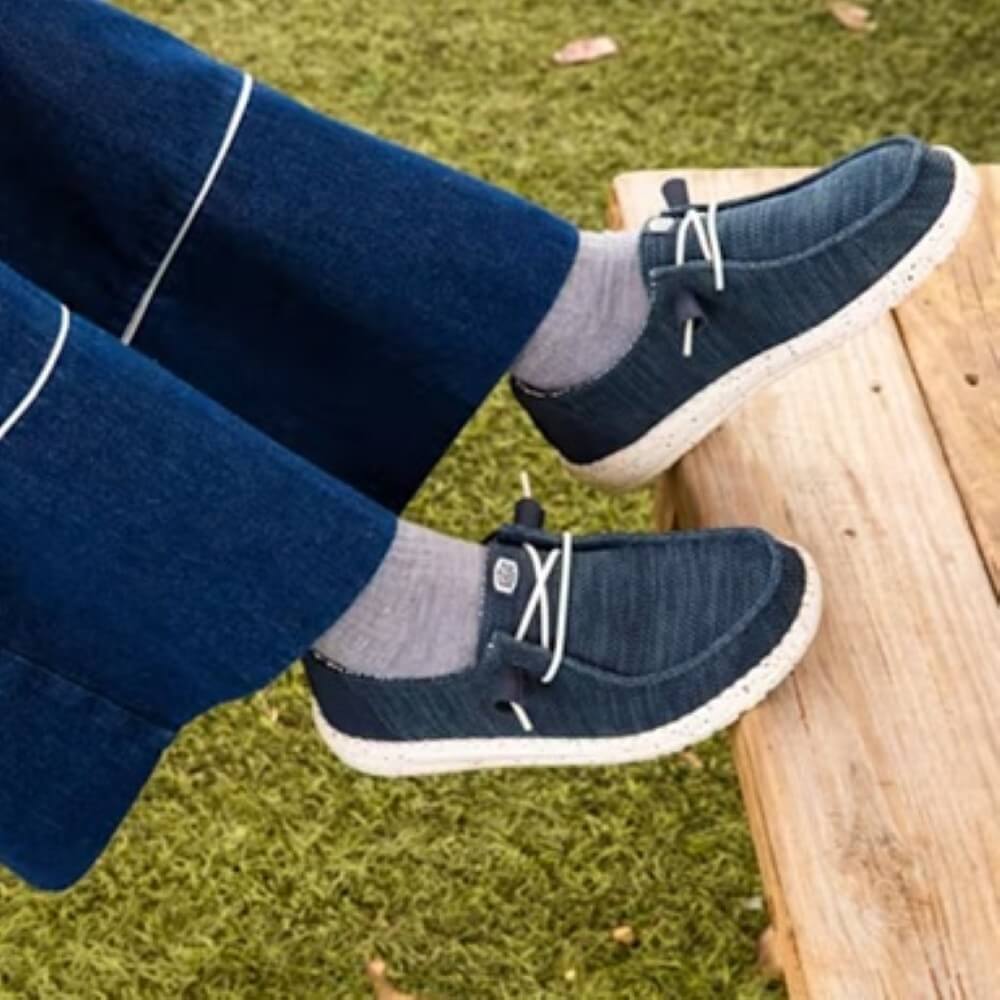 Person wearing HeyDude Navy Canvas shoes