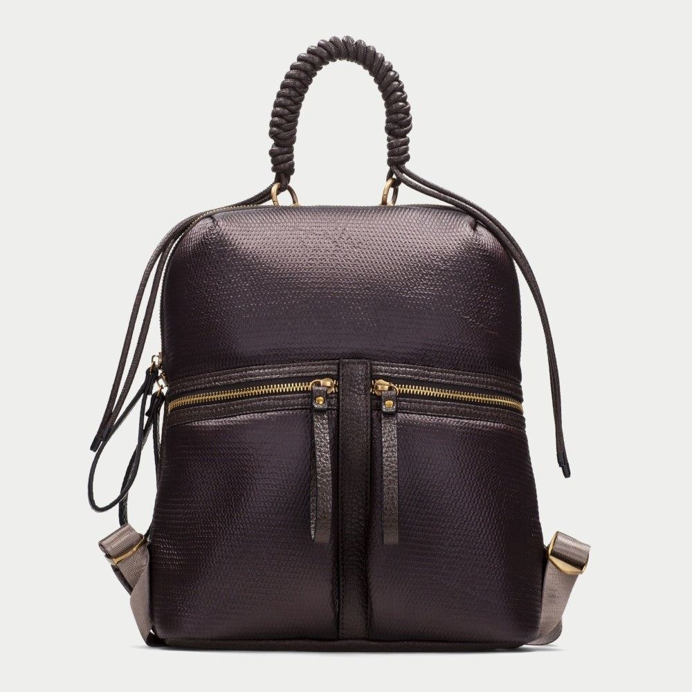 A Hispanitas dark brown textured backpack with a braided top handle, gold-tone zippers, and grey side accents, shown against a light grey background.