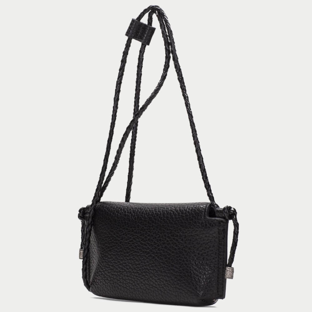 A burgundy pebbled PU leather clutch bag with a flap closure and braided strap details, featuring the brand name 'HISPANITAS' in silver lettering on the front, set against a plain light gray background.