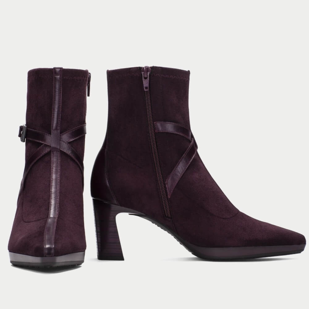 A pair of Hispanitas Bordeaux suede ankle boots with pointed toes, block heels, and decorative side straps with a grey silver buckle, shown against a light grey background.