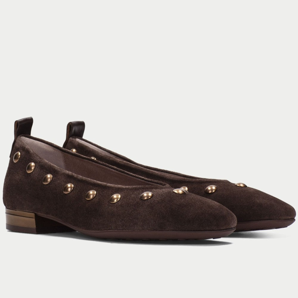 A pair of Hispanitas dark brown suede ballet flats with gold-tone metal studs, shown from a side profile view against a light grey background.