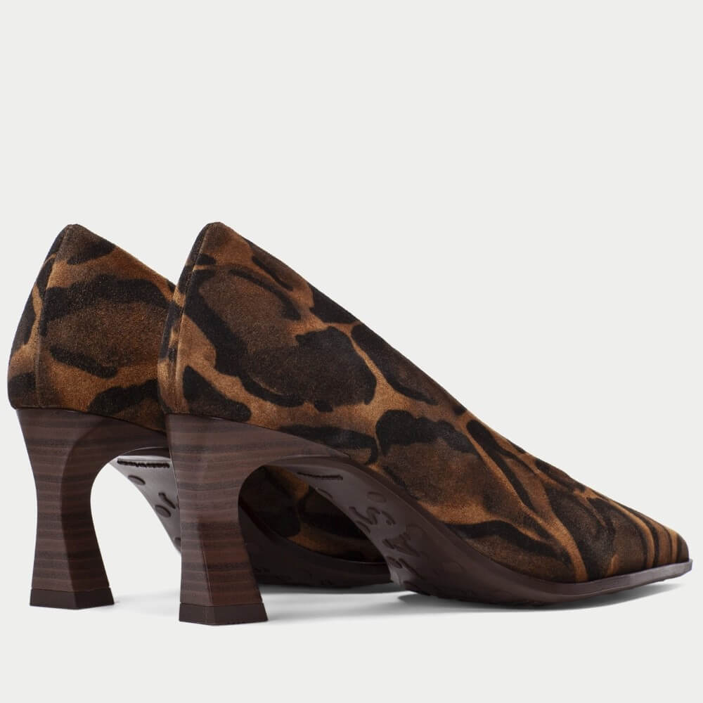 A pair of Hispanitas pointed-toe pumps with a brown and black leopard print pattern and dark brown block heels, shown on a light grey background.