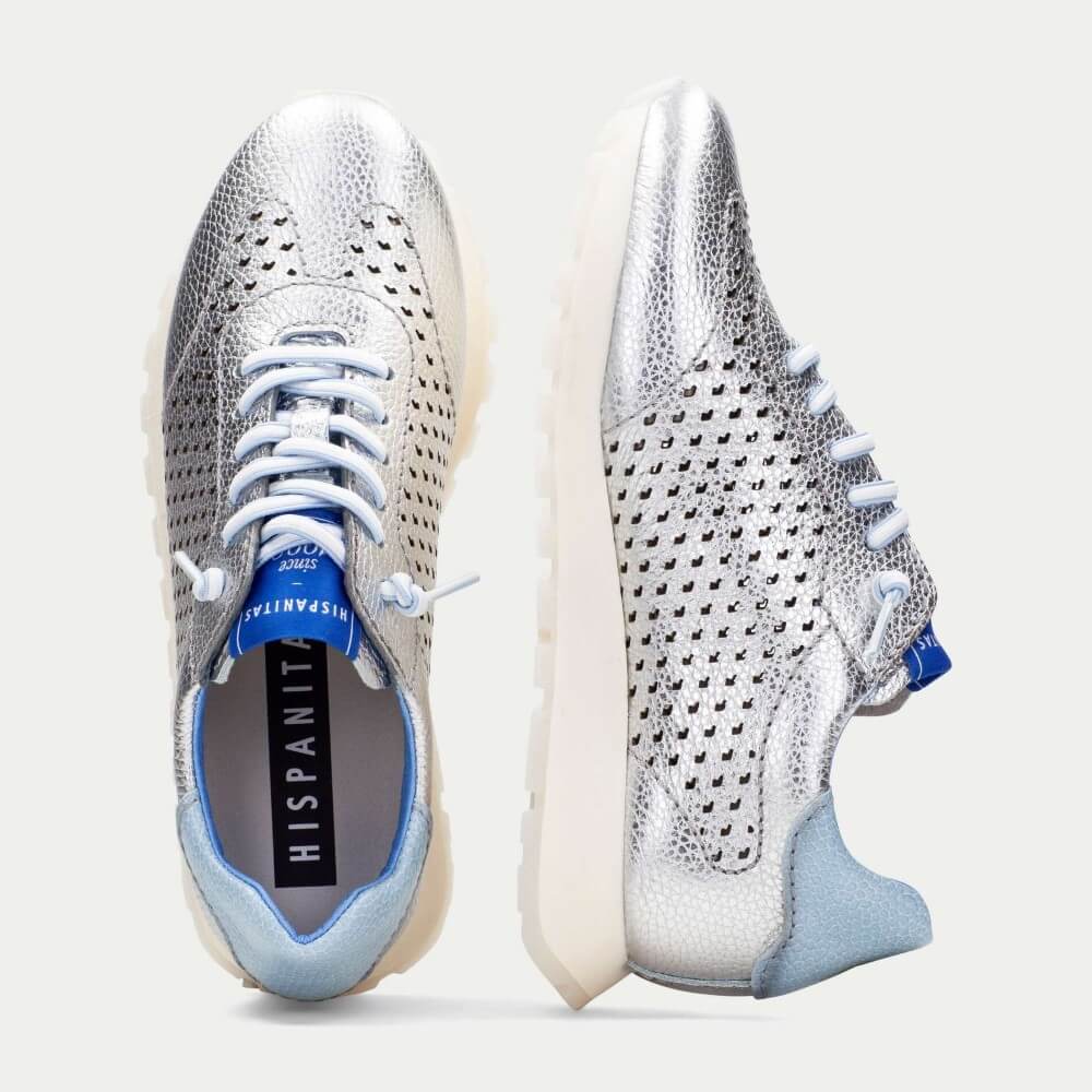 Pair of silver and blue sneakers on a light gray background