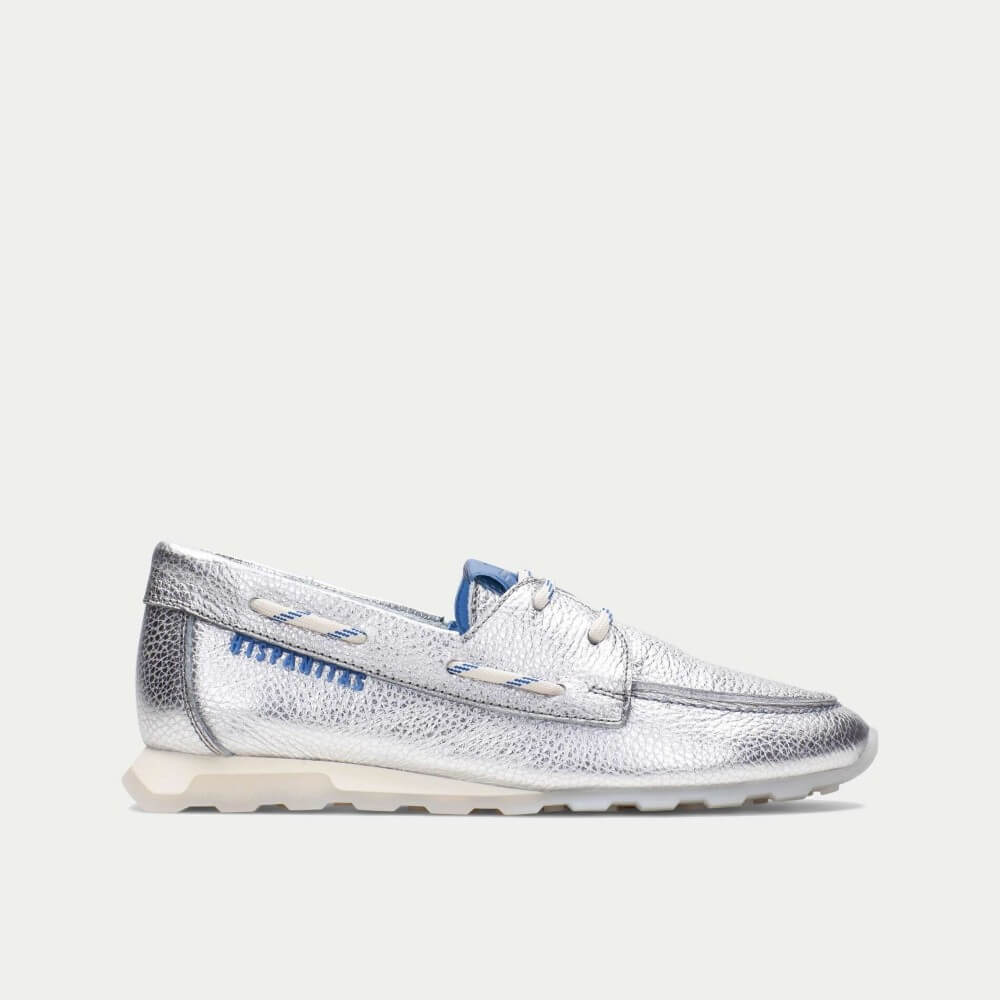 Silver metallic boat shoe on a light gray background