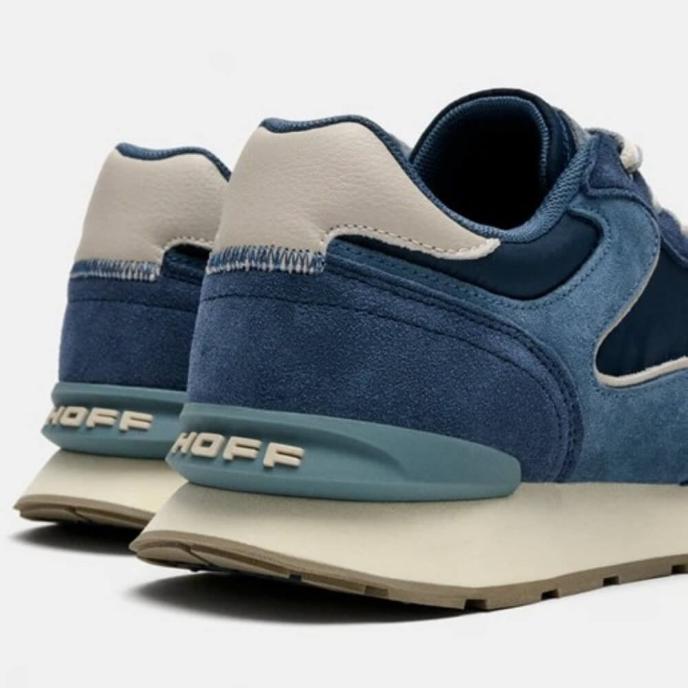 Navy and blue suede sneaker on a light coloured sole