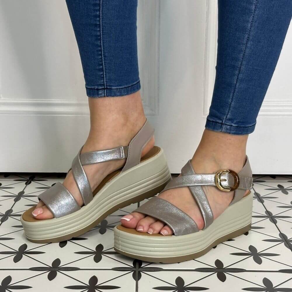 Igi & Co Silver sandals with a platform worn by a person on a patterned floor.