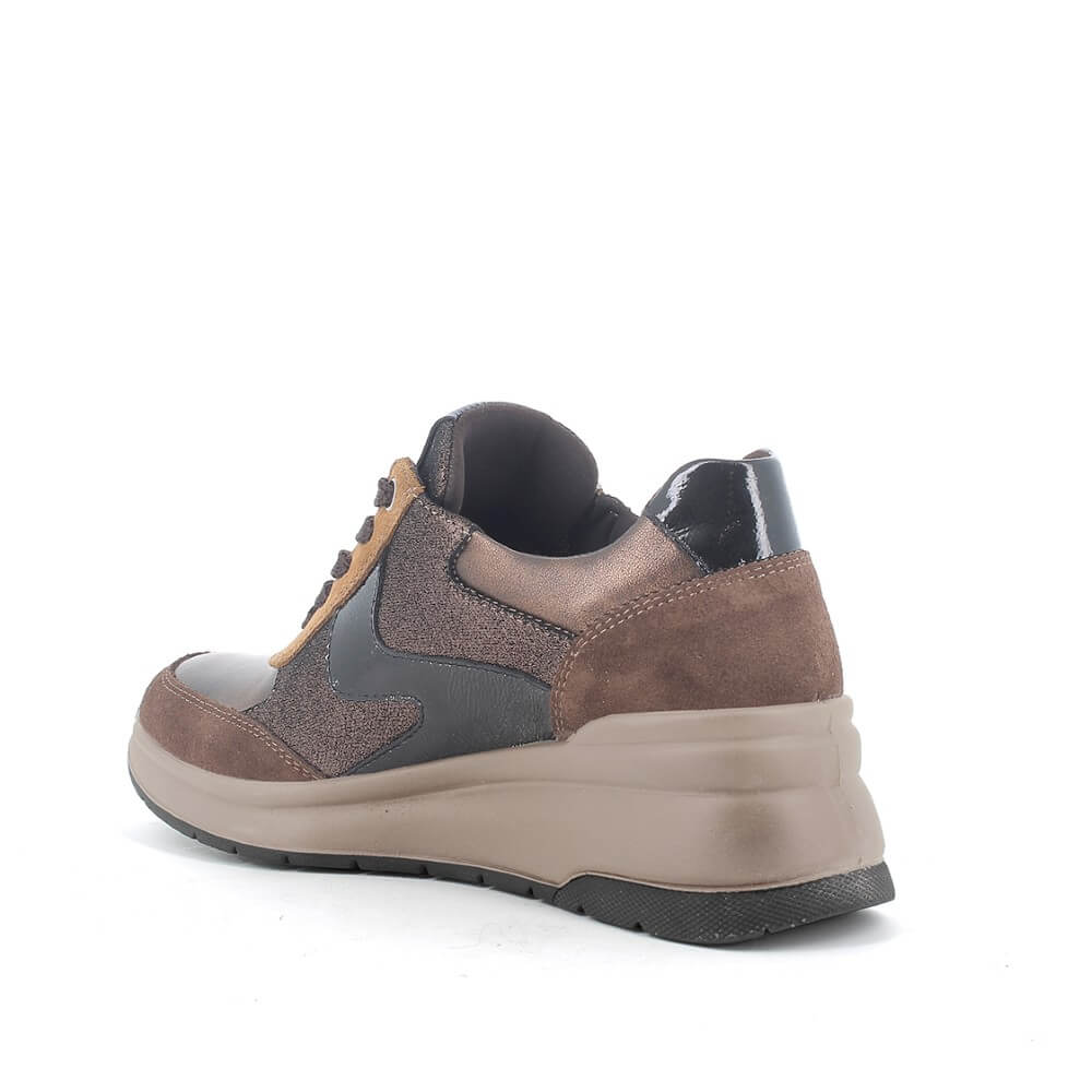 A brown and black platform sneaker with a chunky beige sole, shown from a three-quarters angle on a white background.