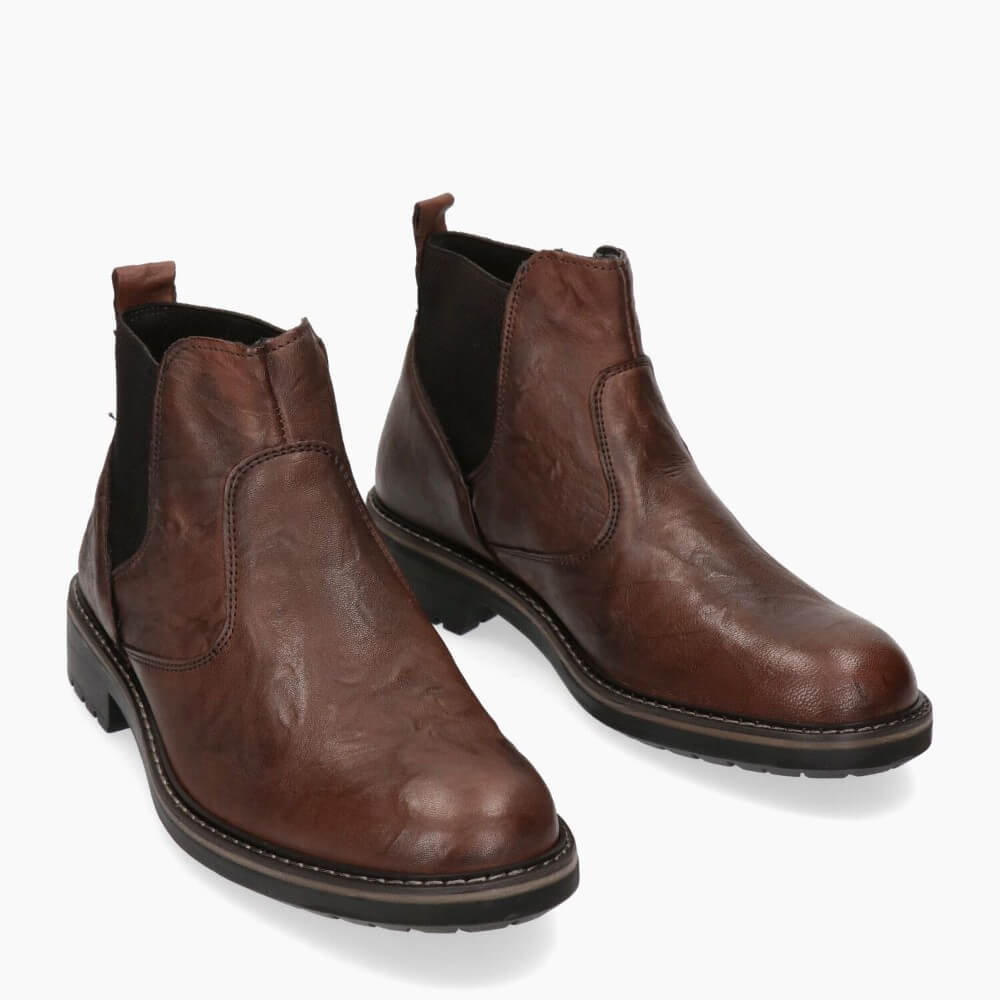 Pair of brown leather boots on a white background