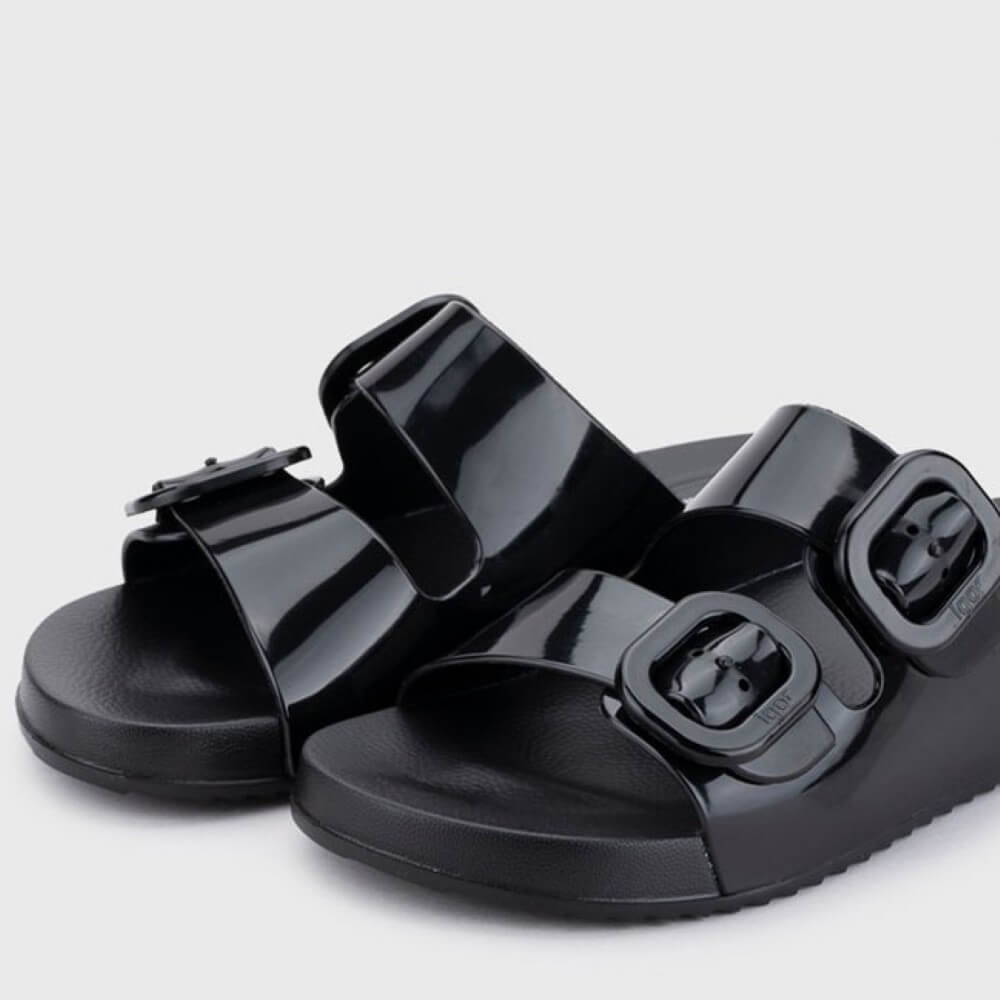 Igor Black sandals with buckle straps on a light grey background