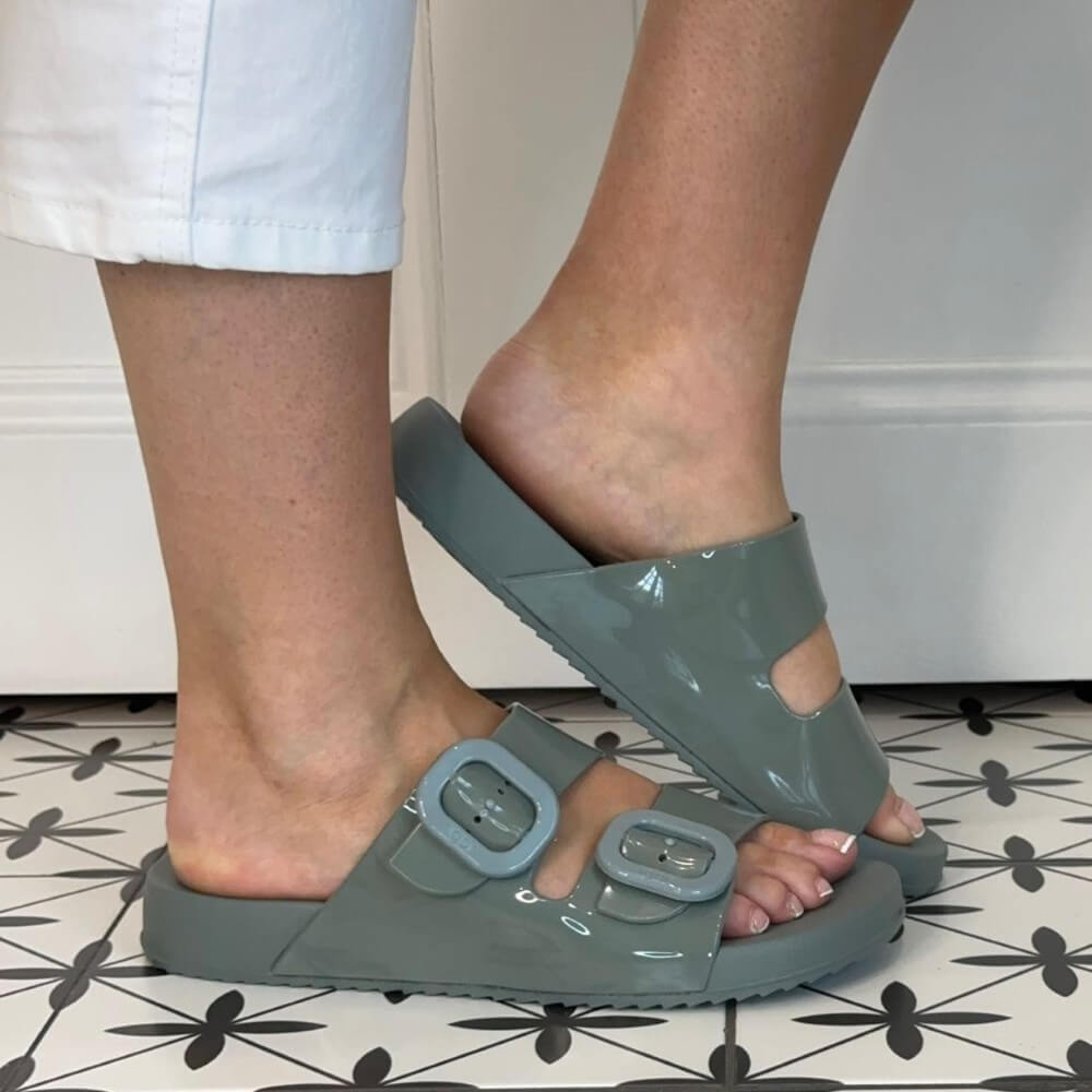 Person wearing Igor Verde Green sandals with buckles on a tiled floor.