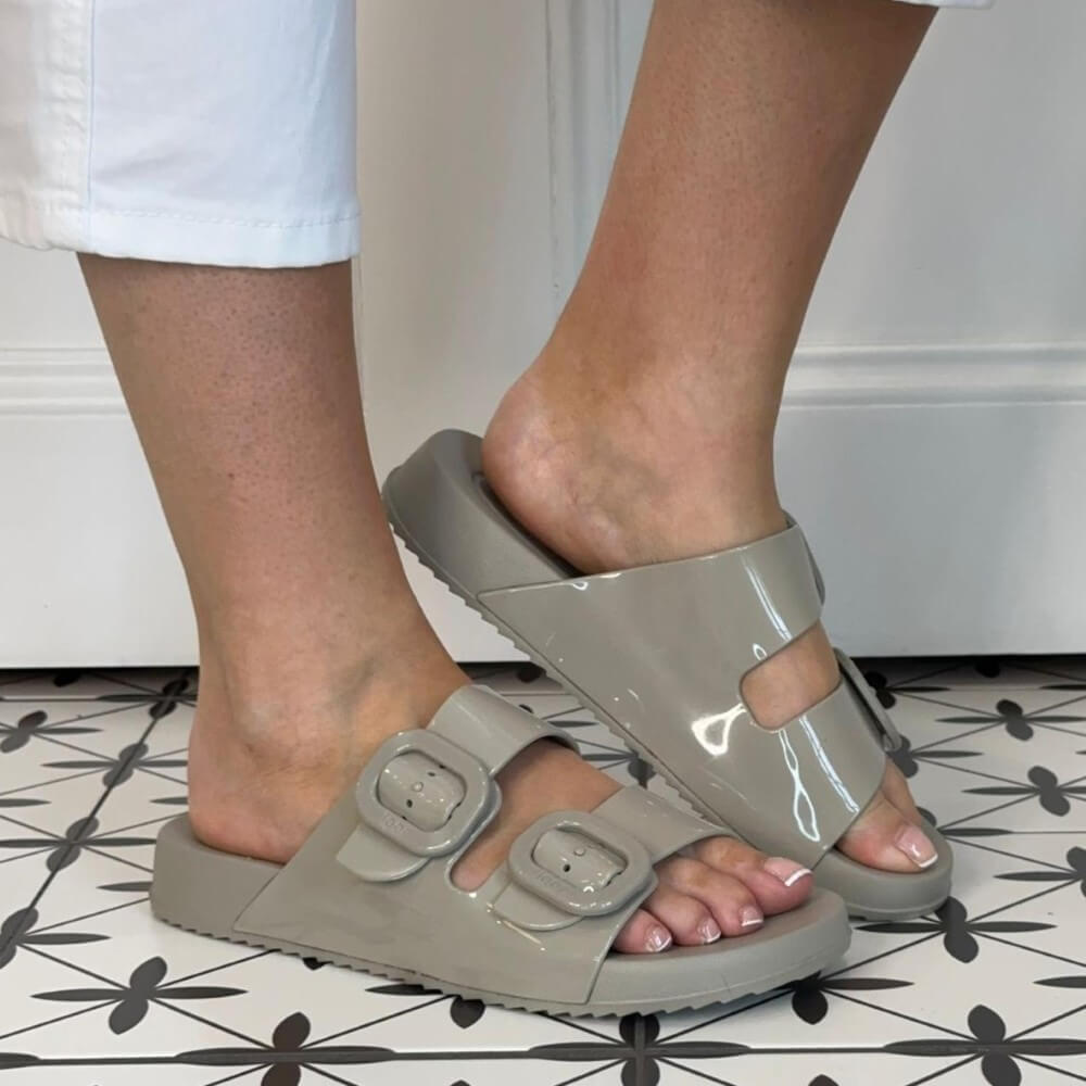 Person wearing Igor Sand grey sandals on a patterned floor