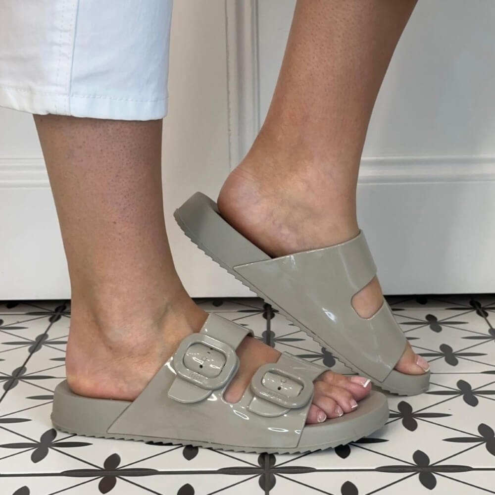 Person wearing Igor Sand grey sandals on a patterned floor