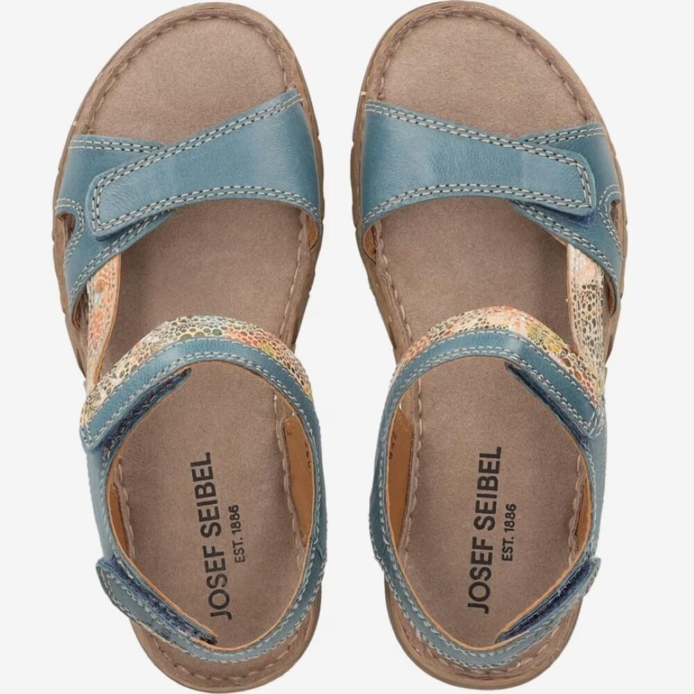 Pair of Josef Seibel blue sandals with floral pattern on a white background