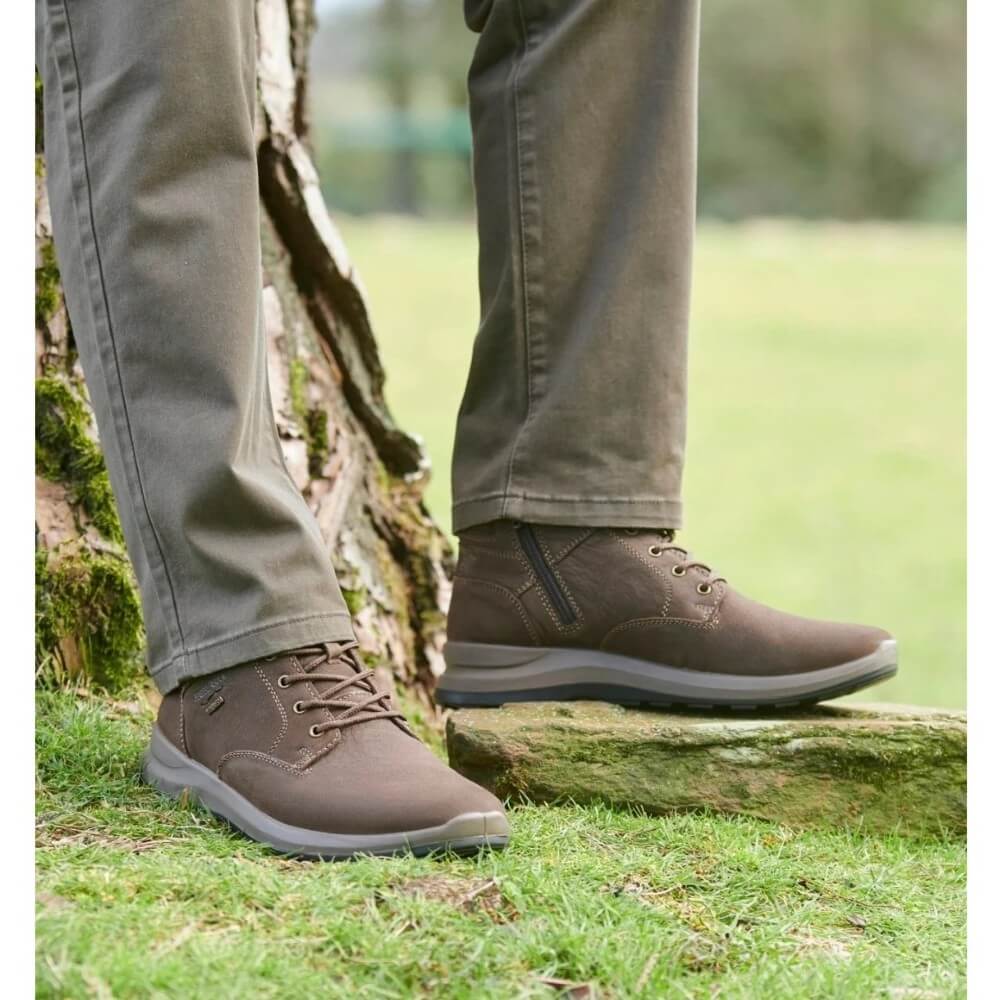 Person wearing a pair of Josef Seibel MARLEY 53 Waterproof Ankle Boots on grass
