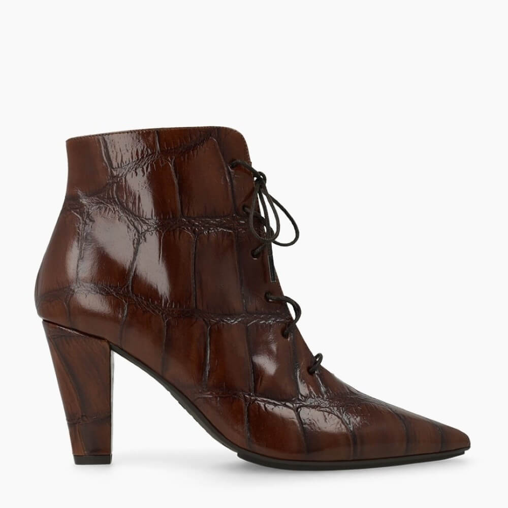 A Lodi brown crocodile-embossed leather ankle boot with a pointed toe and a chunky block heel, featuring black laces, shown against a plain white background.