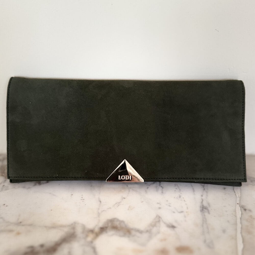Green suede Lodi clutch bag with gold chain on a marble surface