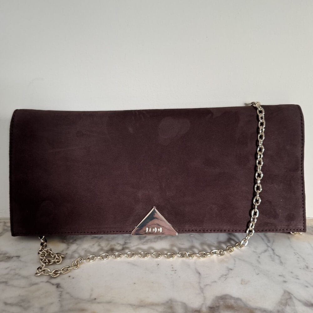 Brown suede clutch bag with a chain strap on a marble surface Lodi L1900