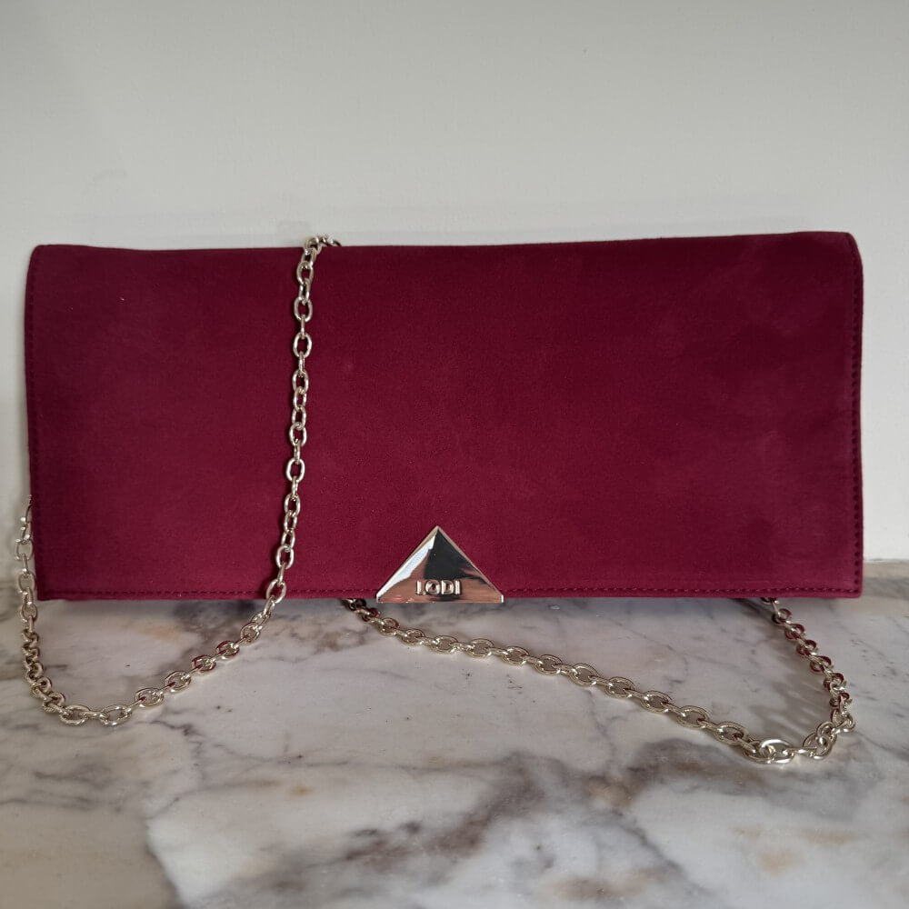 Burgundy Red clutch bag with a gold chain on a marble surface Lodi L1900