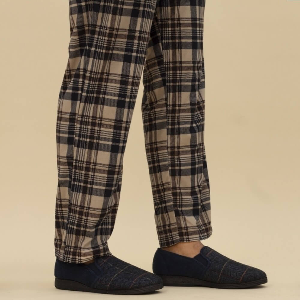 Man in Pj's wearing blue slippers