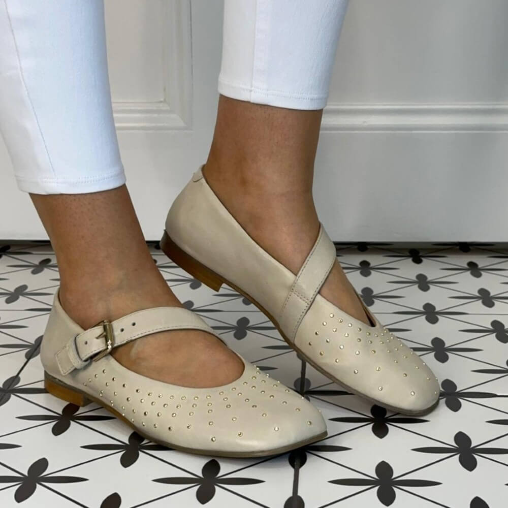 MJUS Beige Mary-jane flat shoes with a strap worn by a person on a patterned floor.
