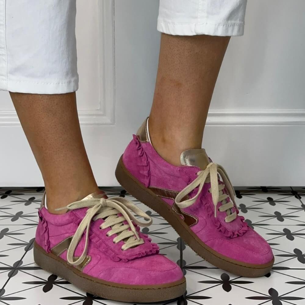 Marco Moreo Pink sneakers with gold star details worn indoors on a patterned floor.