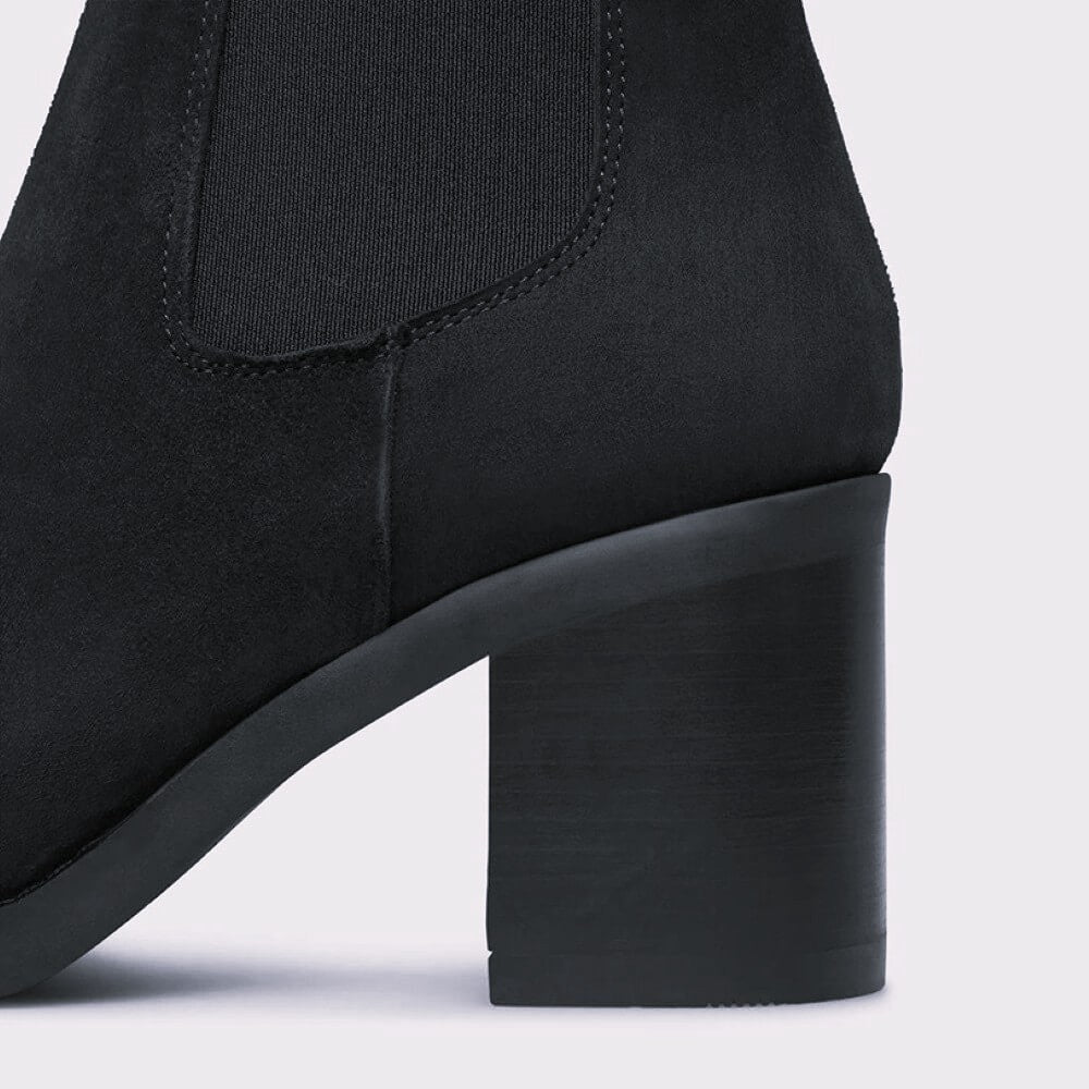Close-up of a black ankle boot with a block heel on a white background