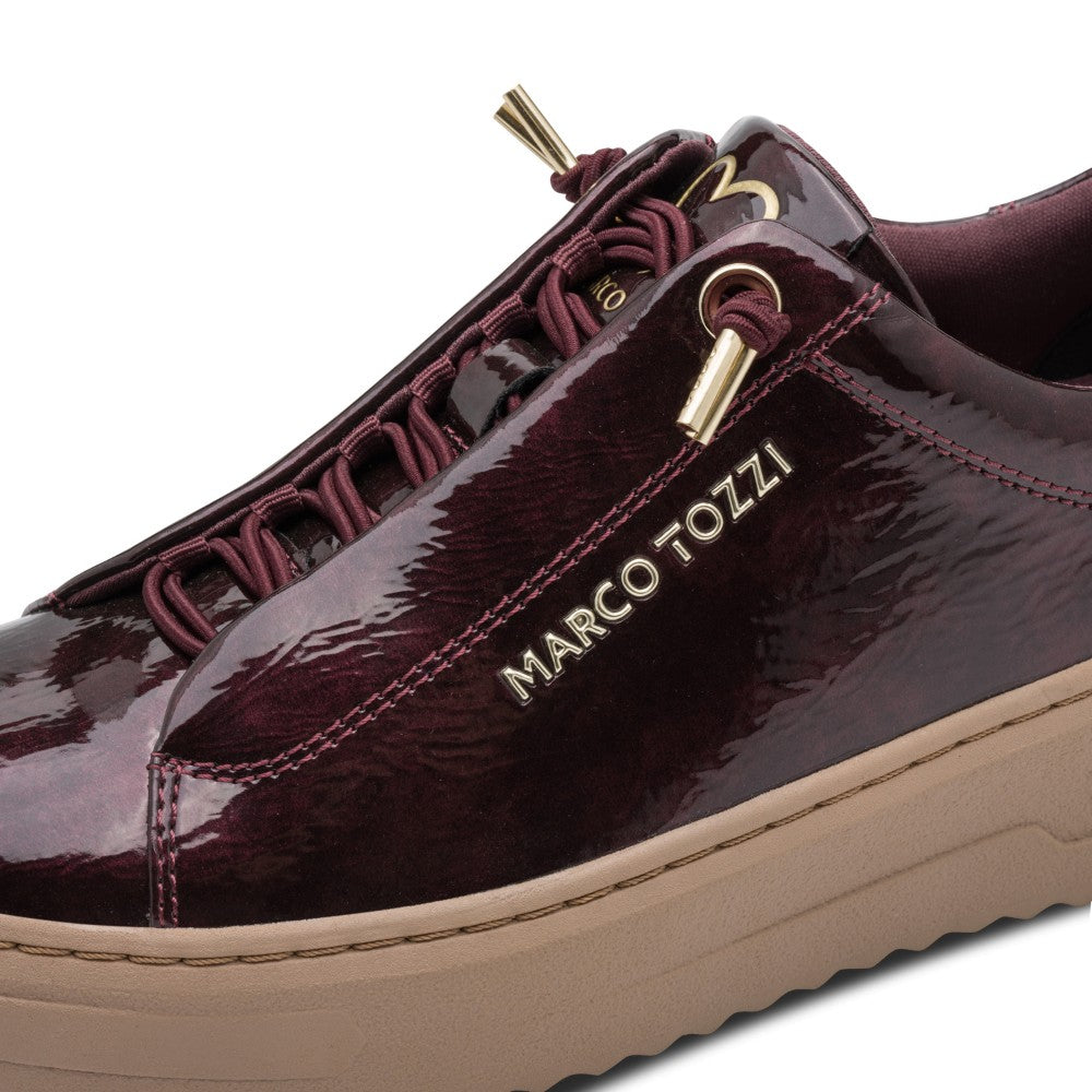 Maroon patent Vegan shoe with gold accents and 'Marco Tozzi' branding on a white background