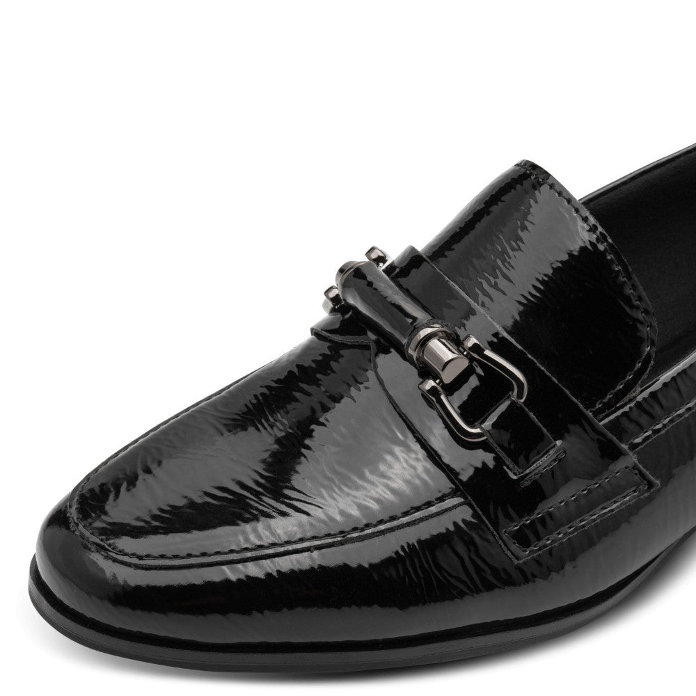 Black patent vegan loafer with a buckle on a white background