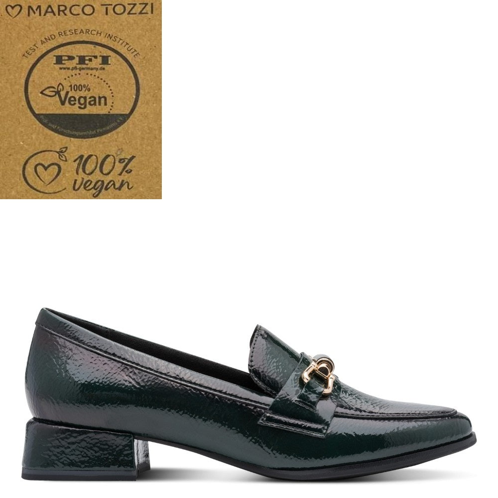 A dark green textured vegan loafer by Marco Tozzi, featuring a gold-tone horsebit detail on the strap. The shoe is displayed on a clean white background with a brown '100% Vegan' certification card from PFI and the Marco Tozzi brand logo in the top-left corner.