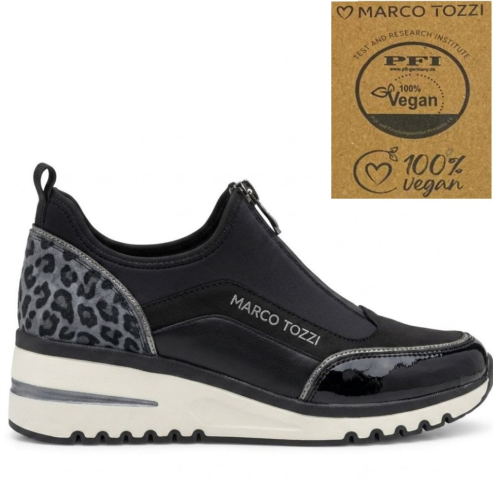 A black slip-on Vegan sneaker with a gray leopard print heel panel, featuring a thick white and black sole. The shoe has 'MARCO TOZZI' printed on the side.