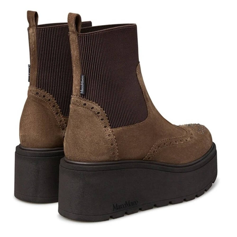 Brown platform boots with black soles on a white background