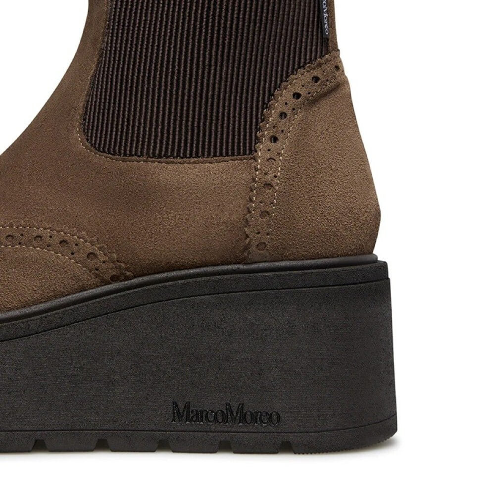 Brown boot with black sole on a white background